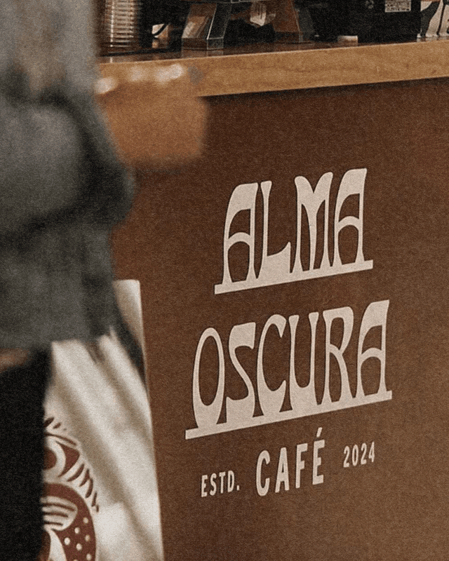 Alma Oscura — café counter with branded signage
